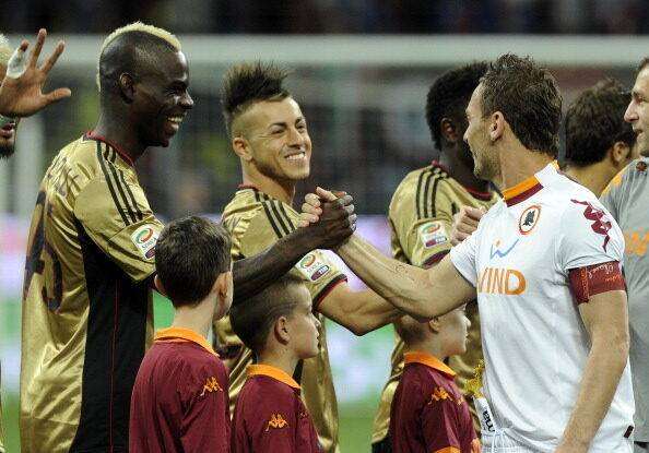 Balotelli and Totti shake hands.