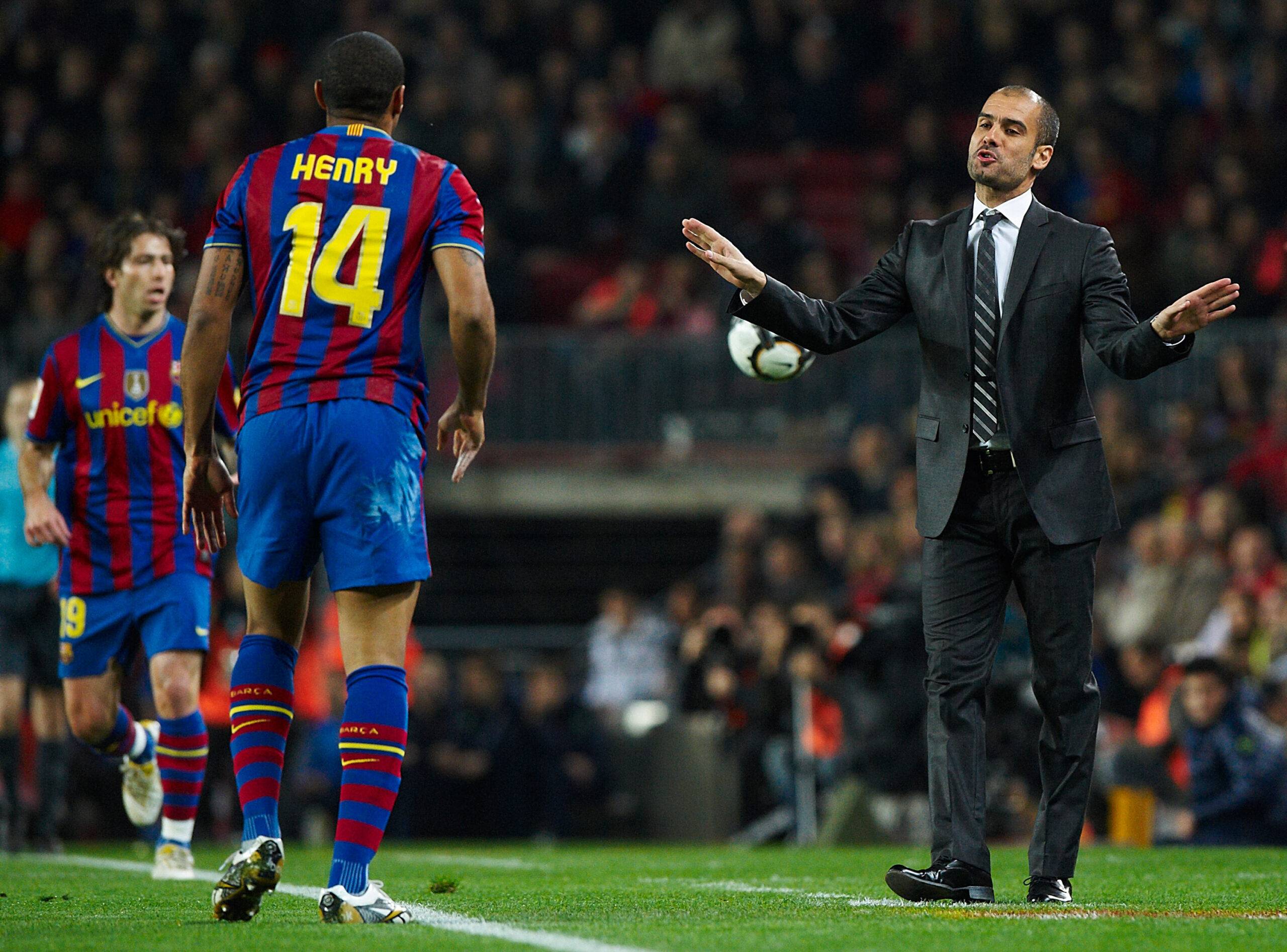 Pep Guardiola speaking to Thierry Henry from touchline at Barcelona