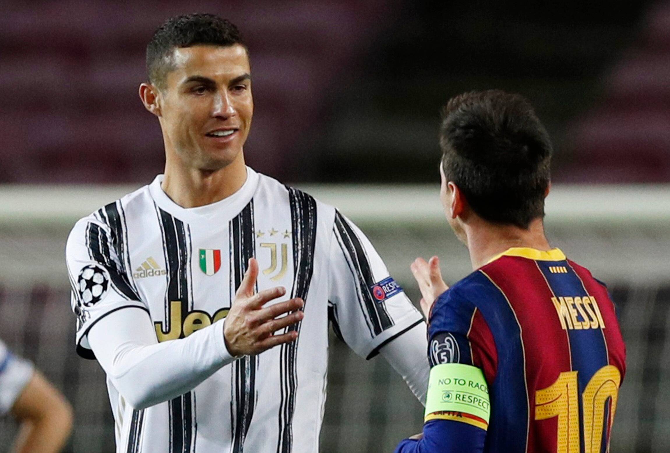 Ronaldo and Messi shake hands.