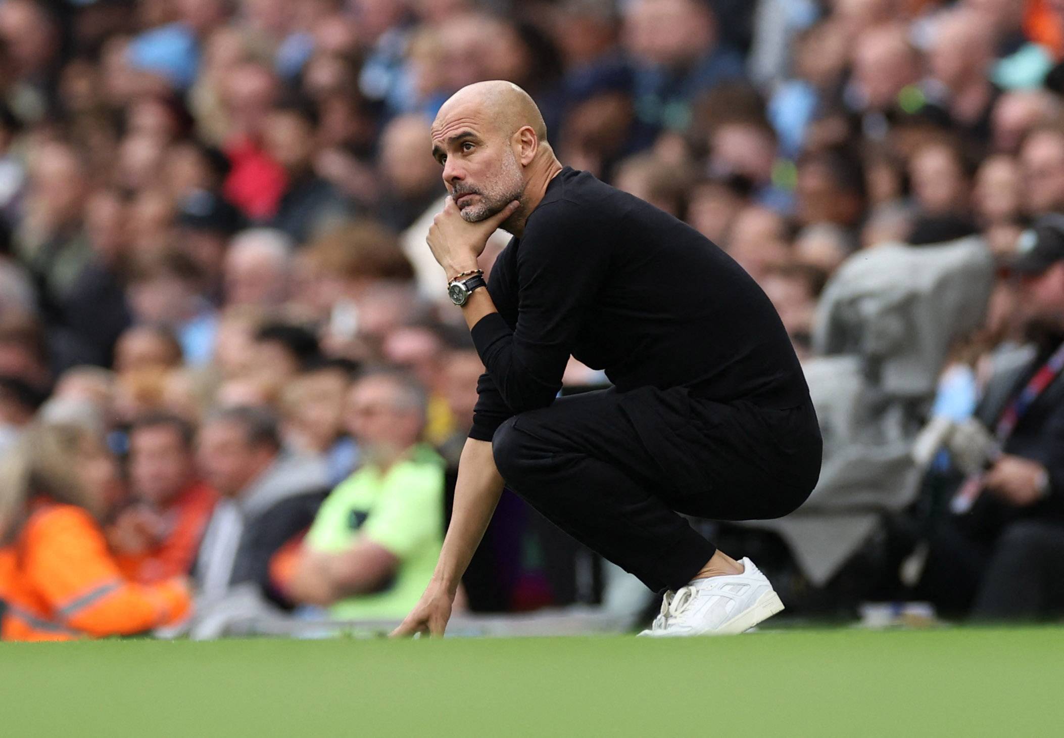 Manchester City boss Pep Guardiola watches on