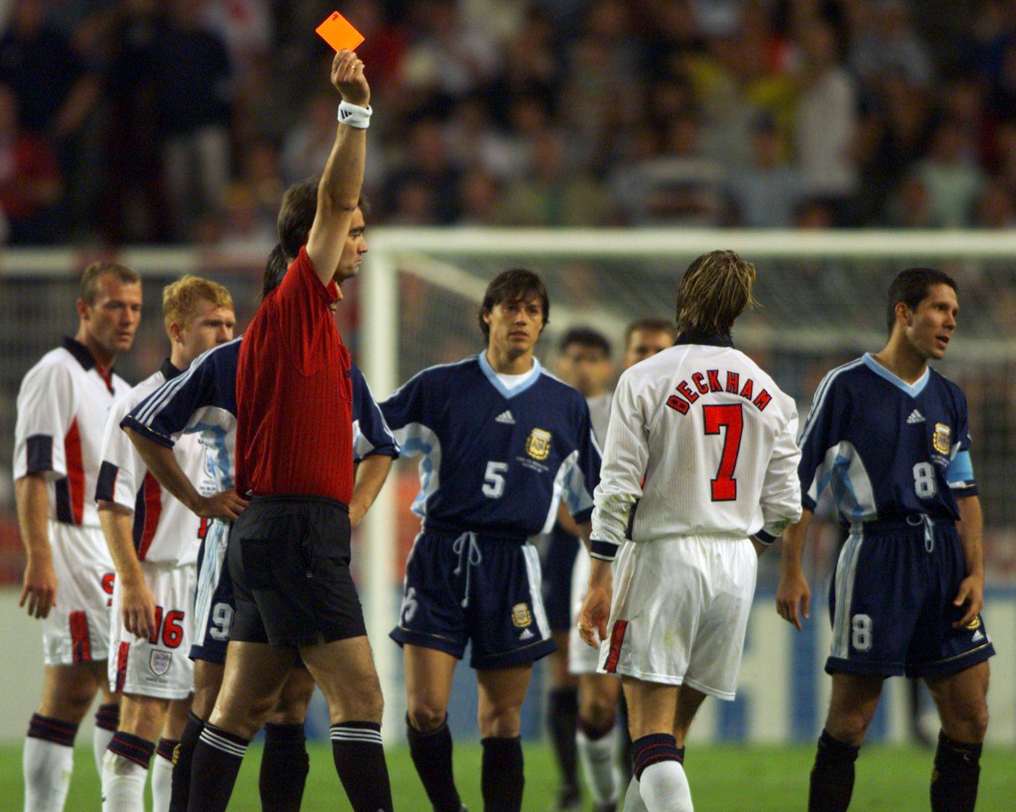 ENGLAND'S BECKHAM IS SENT OFF AFTER AN INCIDENT WITH ARGENTINA'S SIMEONE.