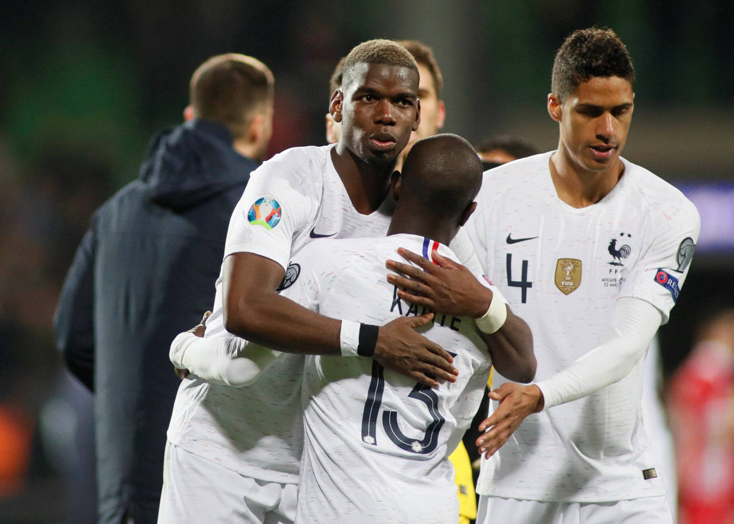 France's Pogba and Kante share a hug.