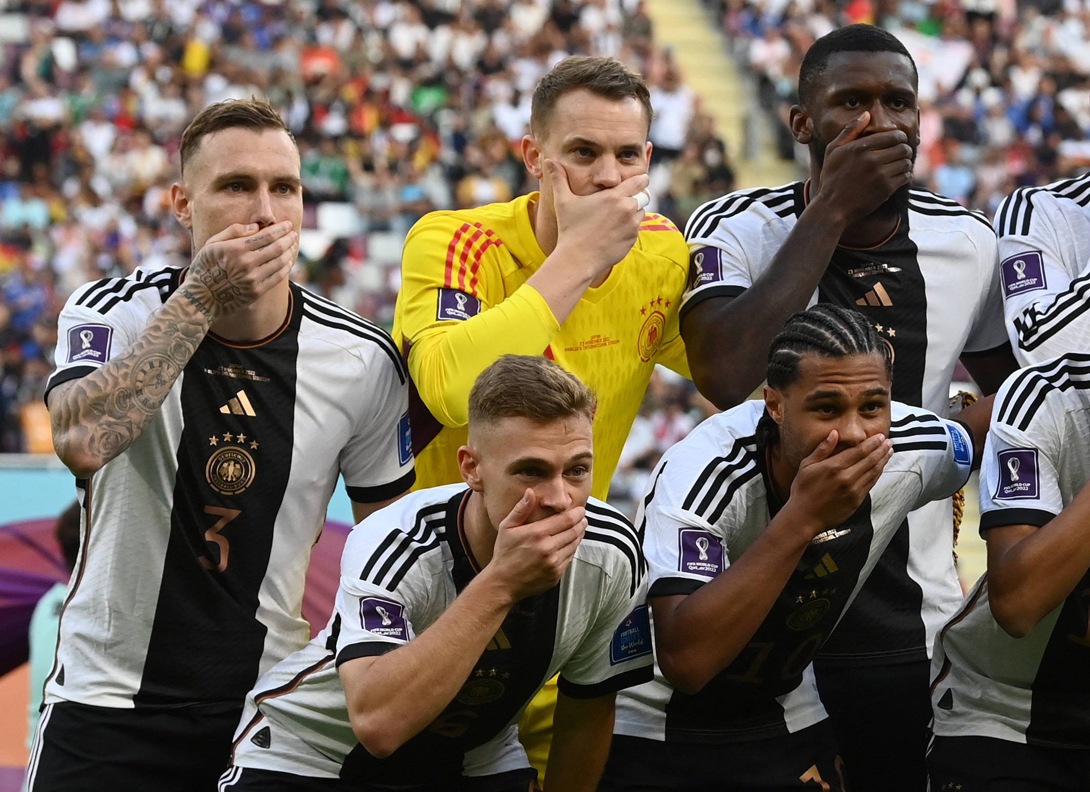 Germany players cover their mouthes.