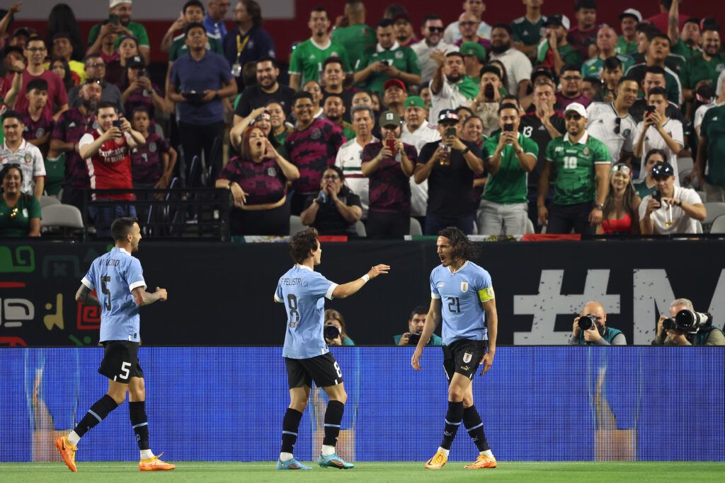 Edinson Cavani #21 of Team Uruguay celebrates with Facundo Pellistri #8 and Matías Vecino #5 after scoring a goal against Team Mexico during the second half of an international friendly match at at State Farm Stadium on June 02, 2022 in Glendale, Arizona. Uruguay defeated Mexico 3-0.