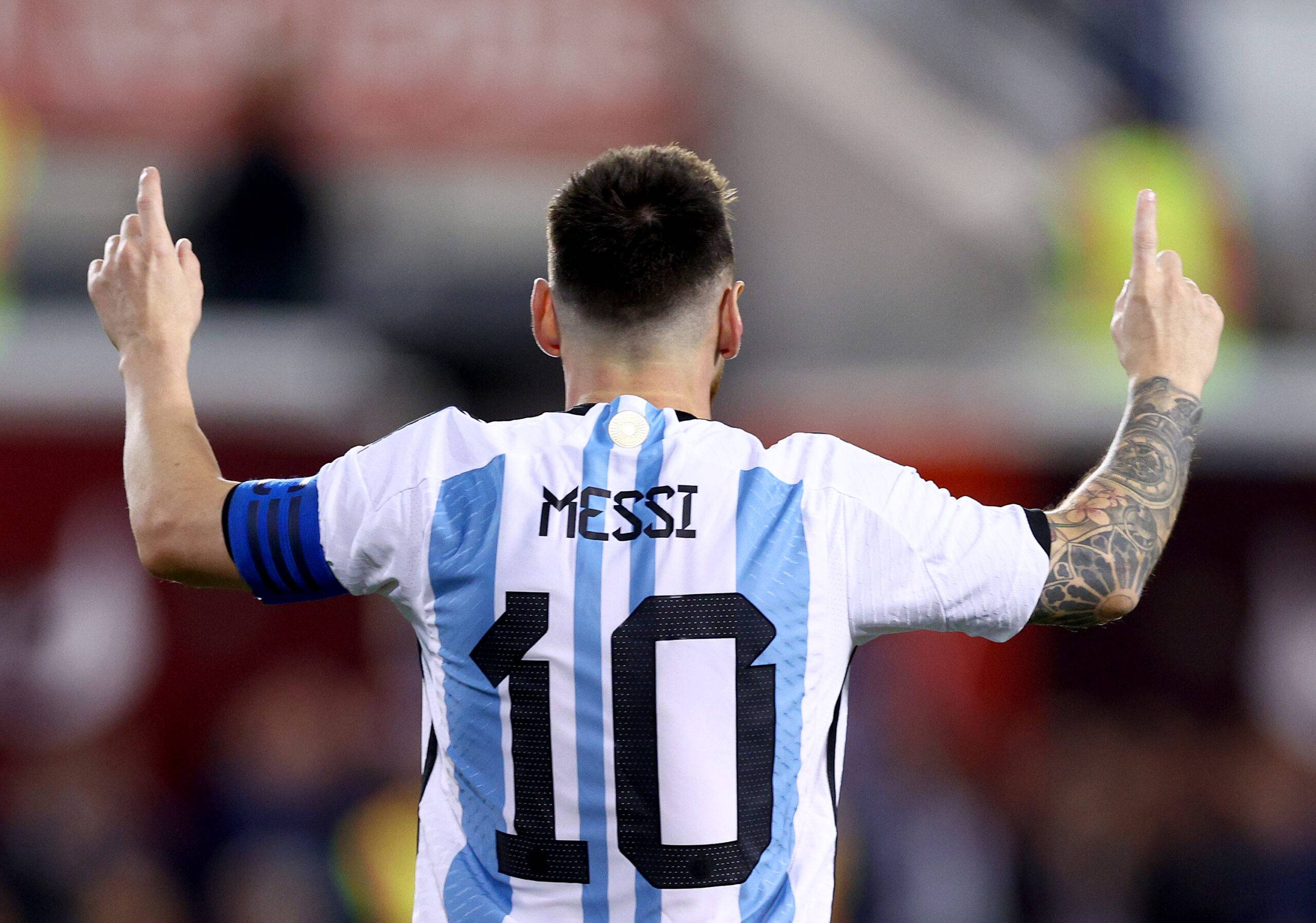 Messi pointing his fingers to the sky after scoring for Argentina