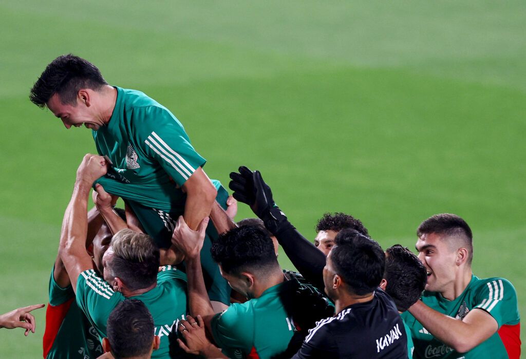 Hirving Lozano #22 of Team Mexico is lifted by teammates after a warm up drill during a training session for Team Mexico at Al Khor Stadium on November 19, 2022 in Doha, Qatar.