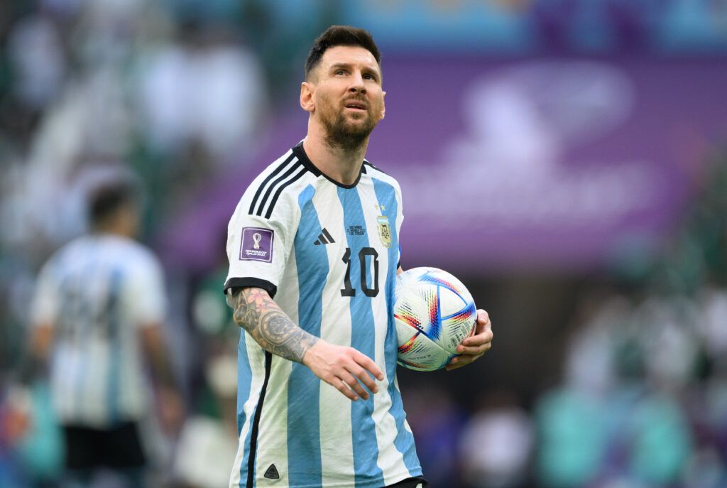 Lionel Messi of Argentina holds an Adidas ball during the FIFA World Cup Qatar 2022