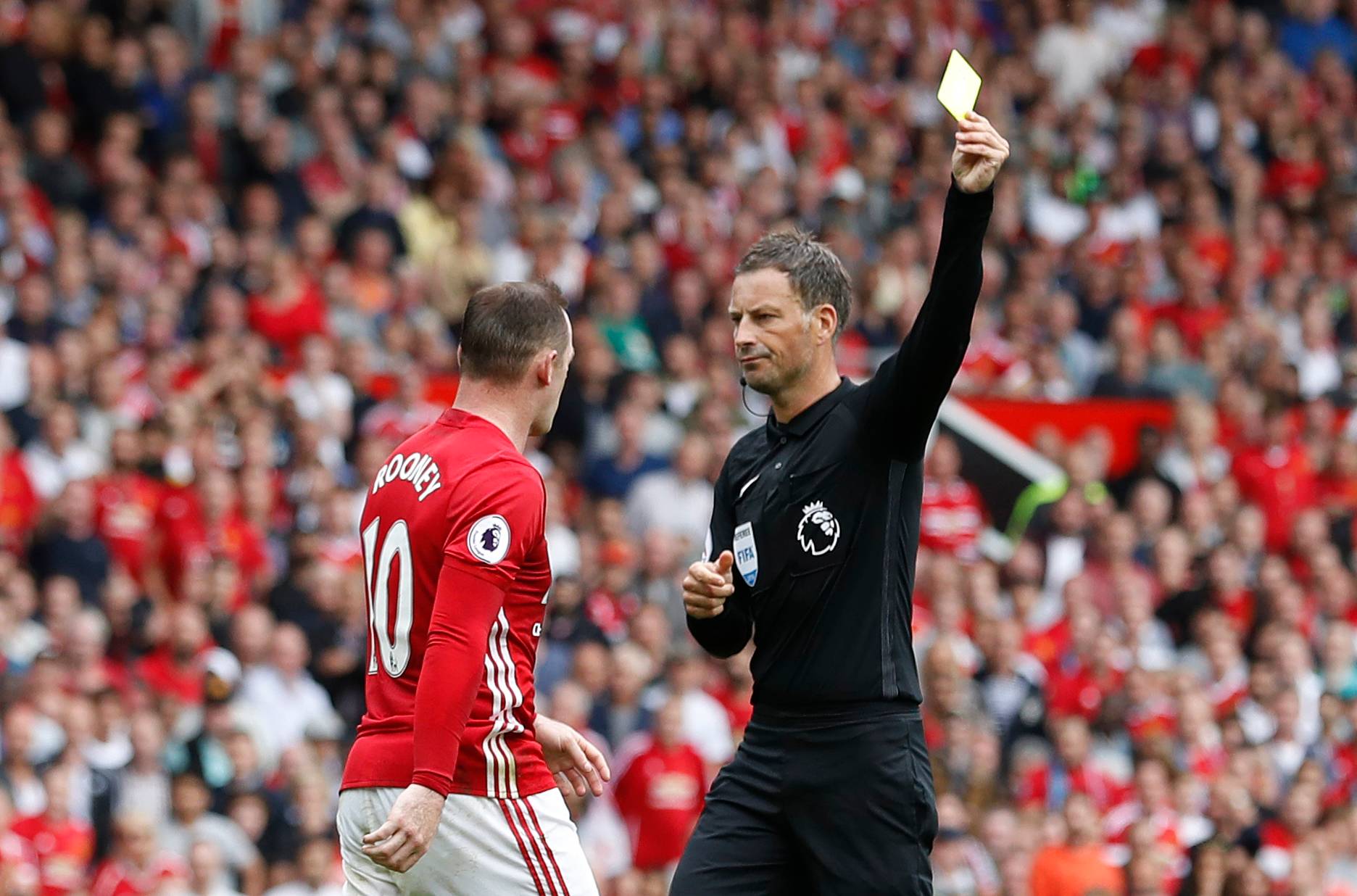 Manchester United's Wayne Rooney receives a booking