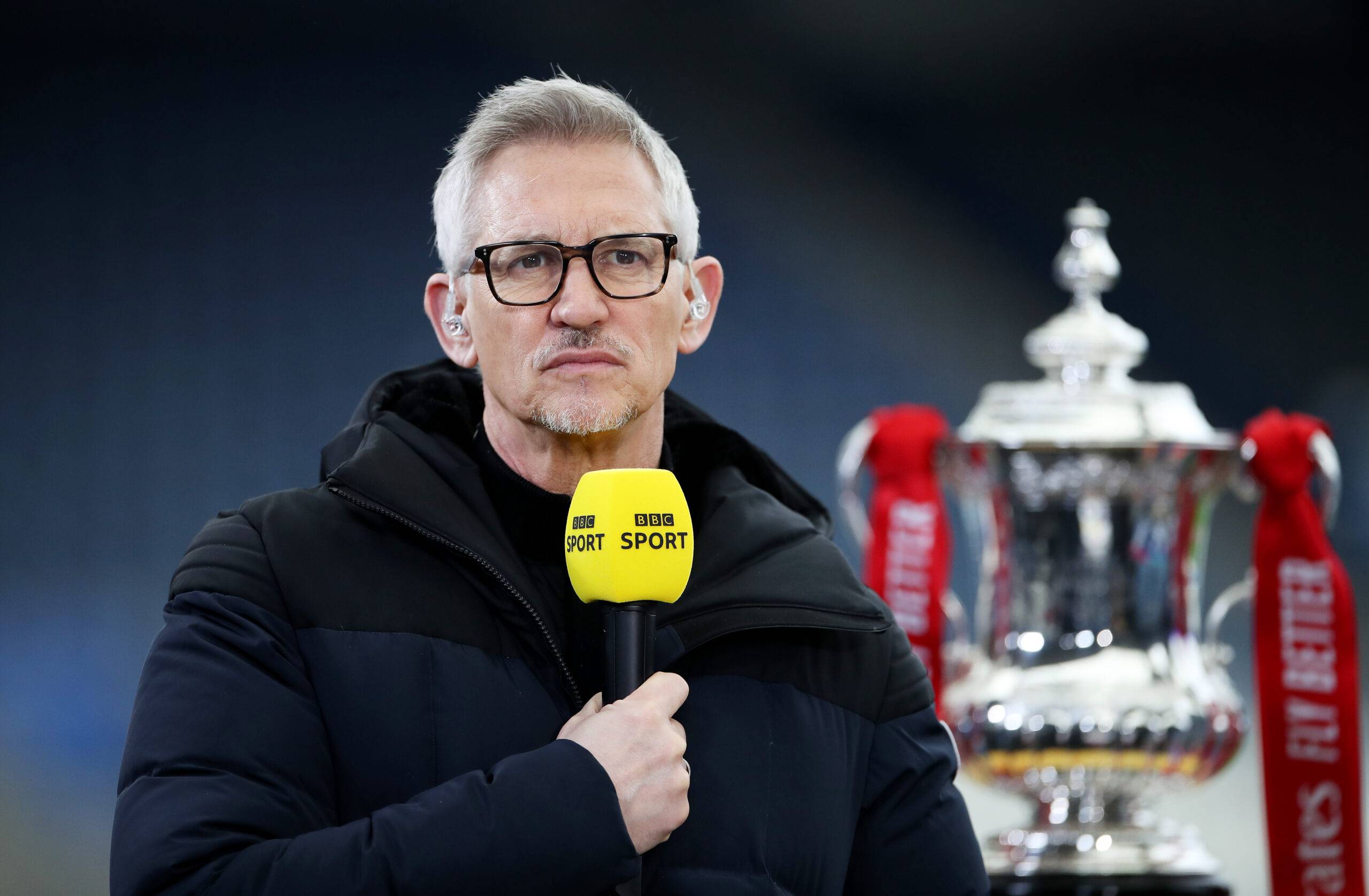 Gary Lineker stands next to the FA Cup
