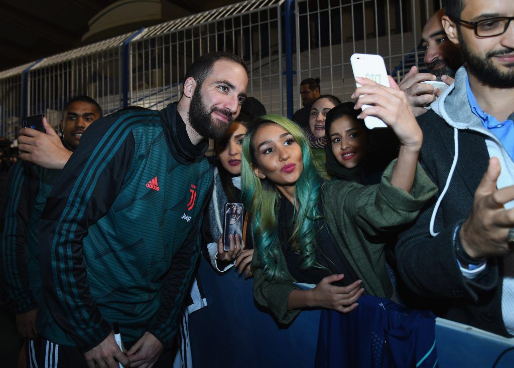Gonzalo Higuain poses with Juventus fans